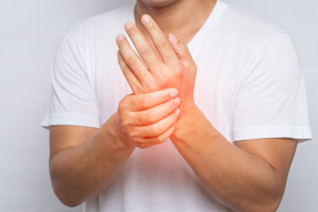 Close up of man suffering from pain in hand or wrist
